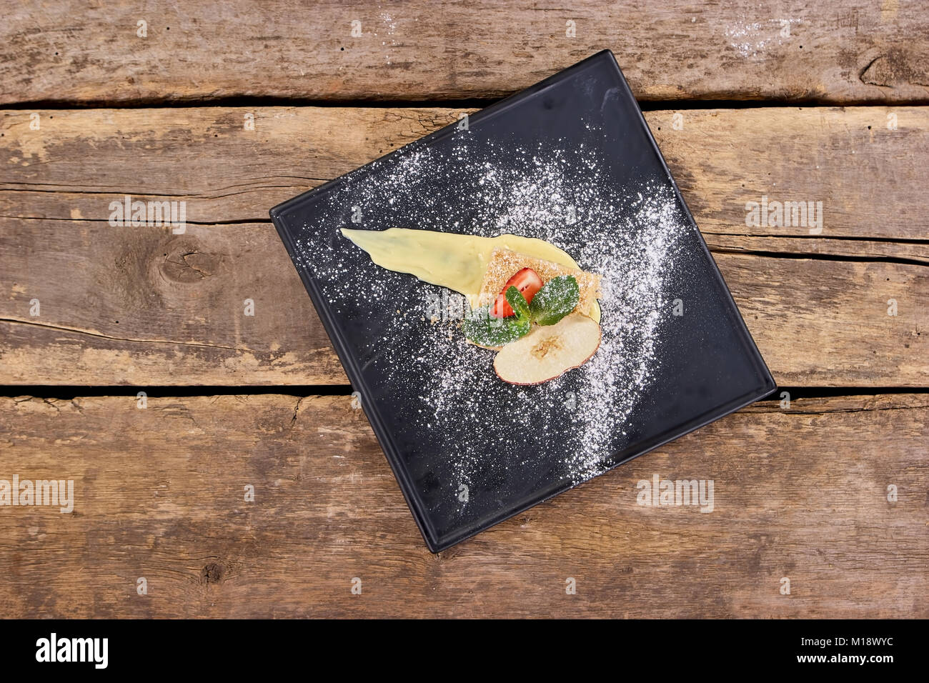 Vue de dessus gâteau avec pomme, fraise, menthe et la farine blanche. Banque D'Images