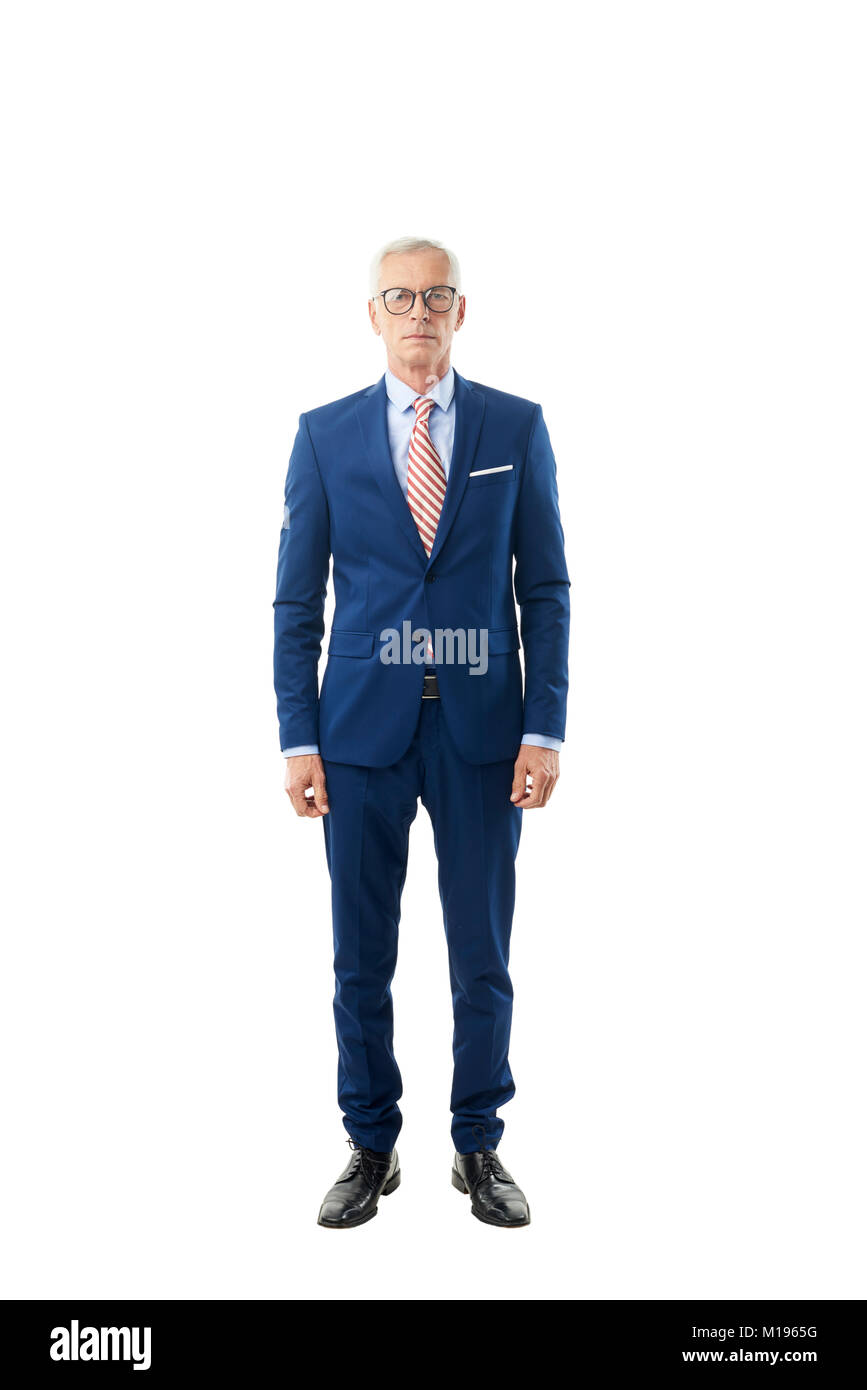 Longueur totale d'un senior businessman wearing costume et looking at camera while standing à isolé sur fond blanc. Banque D'Images