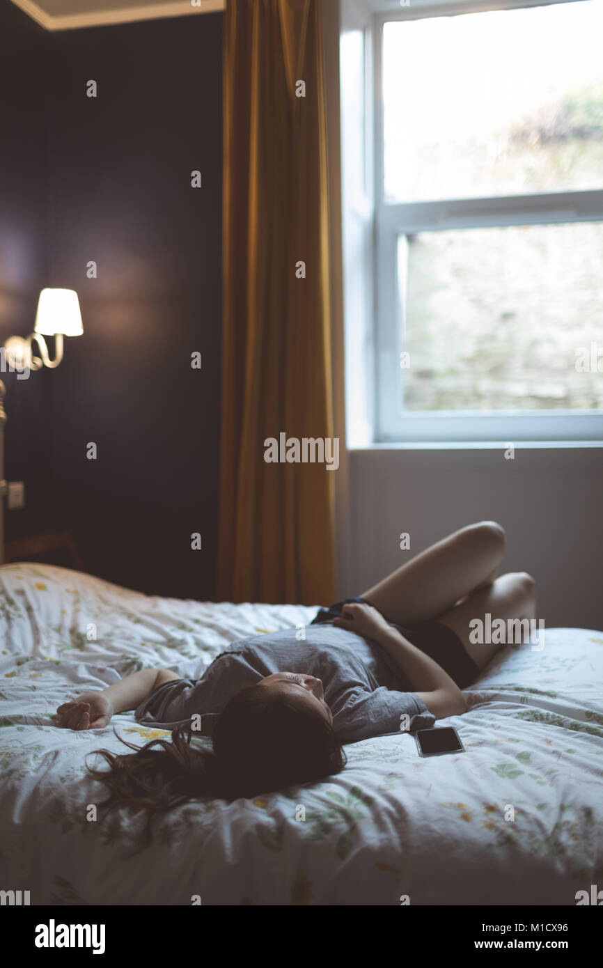 Woman in bedroom Banque D'Images