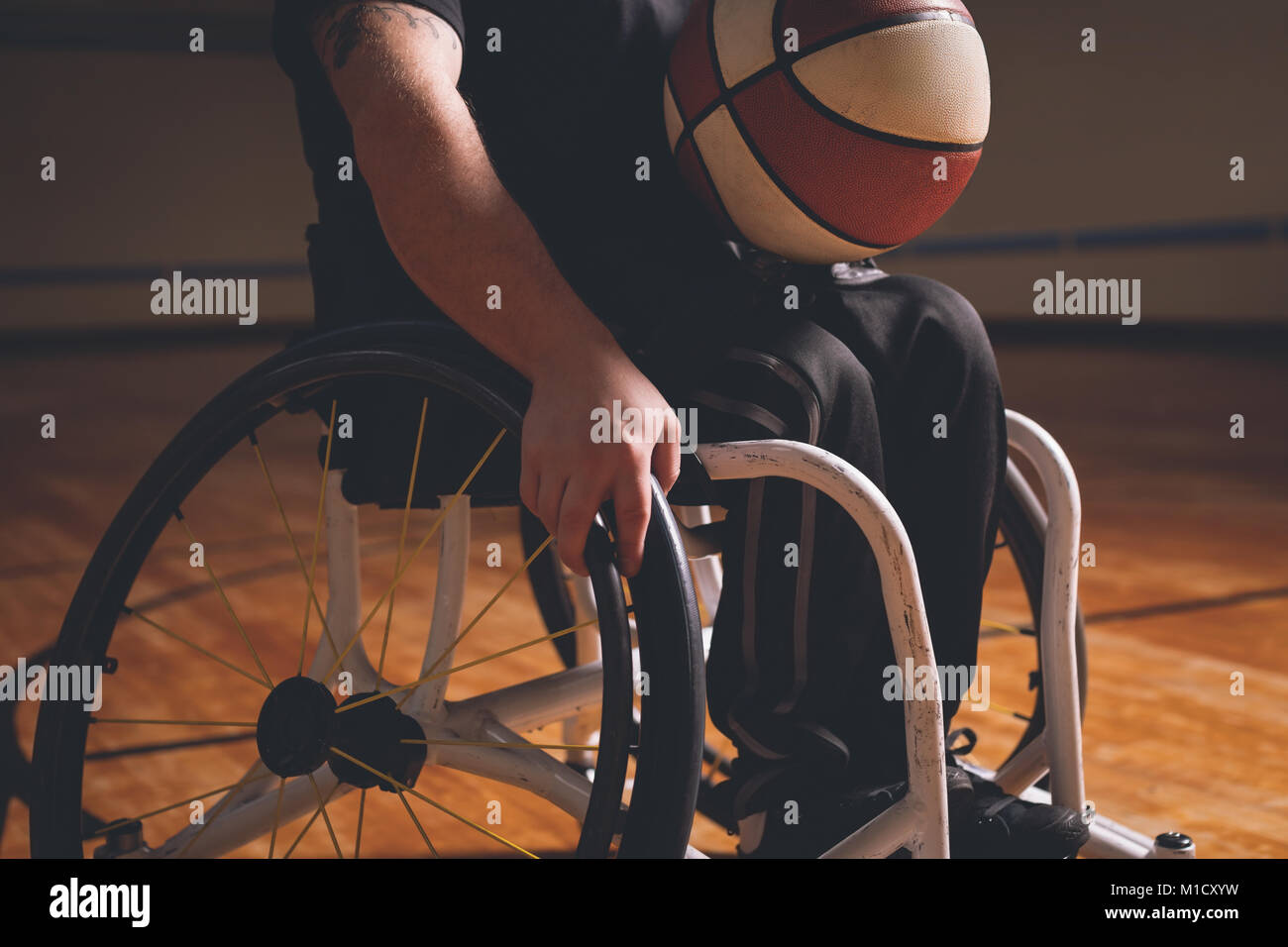 Homme handicapé pratiquant le basket-ball dans la cour Banque D'Images