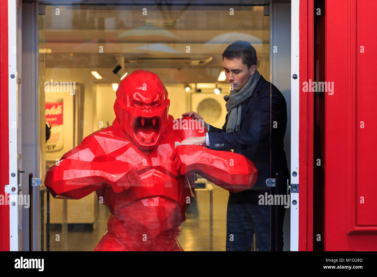Le gorille rouge sculpture intitulée 'Wild Kong' par le sculpteur et artiste Richard Olinsky est nettoyé par le personnel à la Galerie Montmartre à Paris, France Banque D'Images