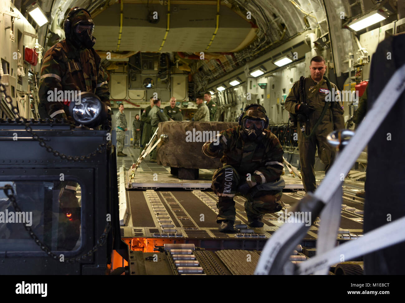 Aviateurs affectés à 62e Airlift Wing et 627ème Air Base Group charger un C-17 Globemaster III au cours de l'effort à Winterhook Joint Base Lewis-McChord, dans l'État, le 25 janvier 2018. Au cours de l'exercice, de l'équipe d'aviateurs McChord ont été testés et évalués sur leur capacité à porter correctement axé sur la mission de la posture de protection, s'acquitter de leurs fonctions de jour en jour et d'administrer l'aide et de soins buddy pendant une simulation de menace chimique. (U.S. Air Force Banque D'Images