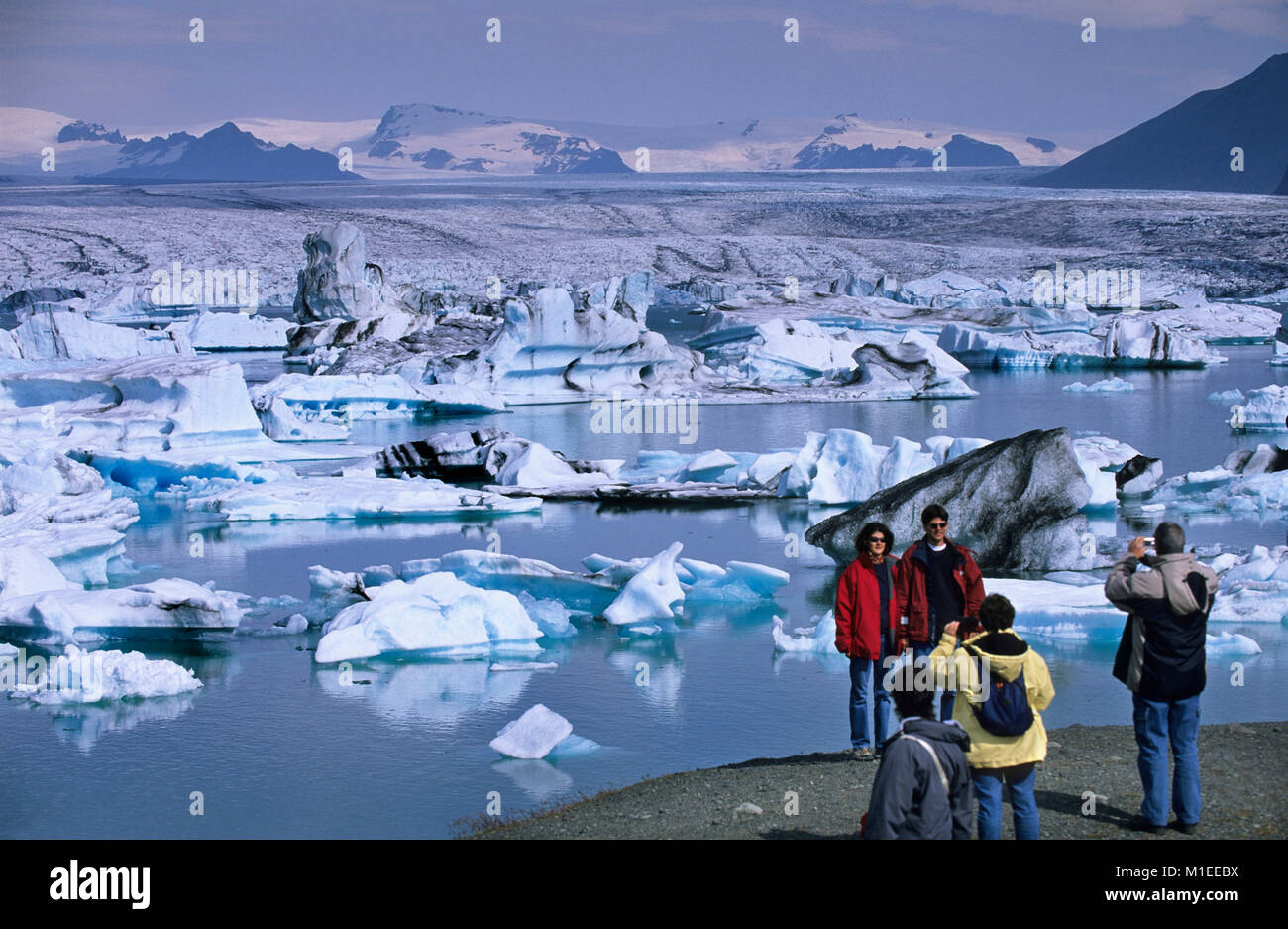 L'Islande. Jokulsarlon. Les icebergs flottant dans le lac Jokulsarlon. Les touristes par le lac avec des icebergs. Banque D'Images