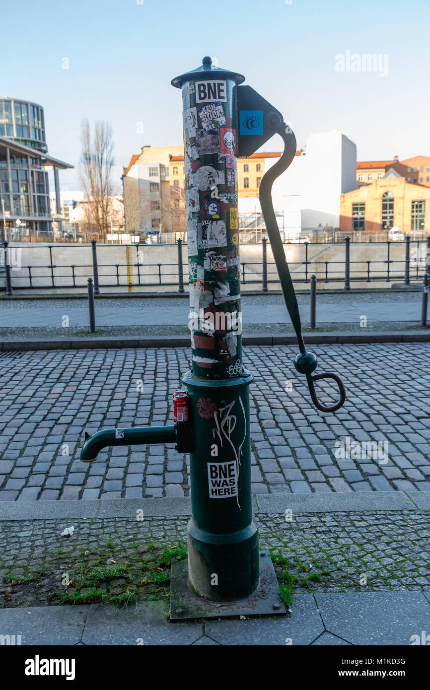 Des vieux de la pompe à eau publique couverte d'autocollants à Berlin, Allemagne Banque D'Images