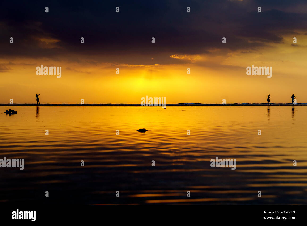 Silhouette de trois personnes debout sur la plage, Gili Trawangan, Lombok Utara, Nusa Tenggara Ouest, Indonésie Banque D'Images