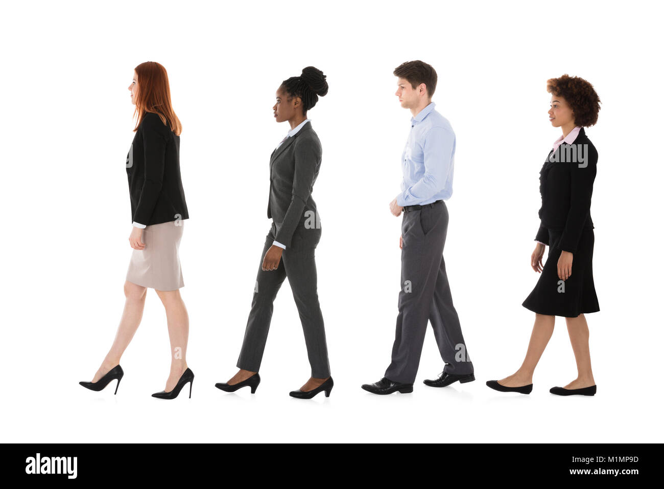 Société multiraciale Businesspeople Walking in Row Against White Background Banque D'Images