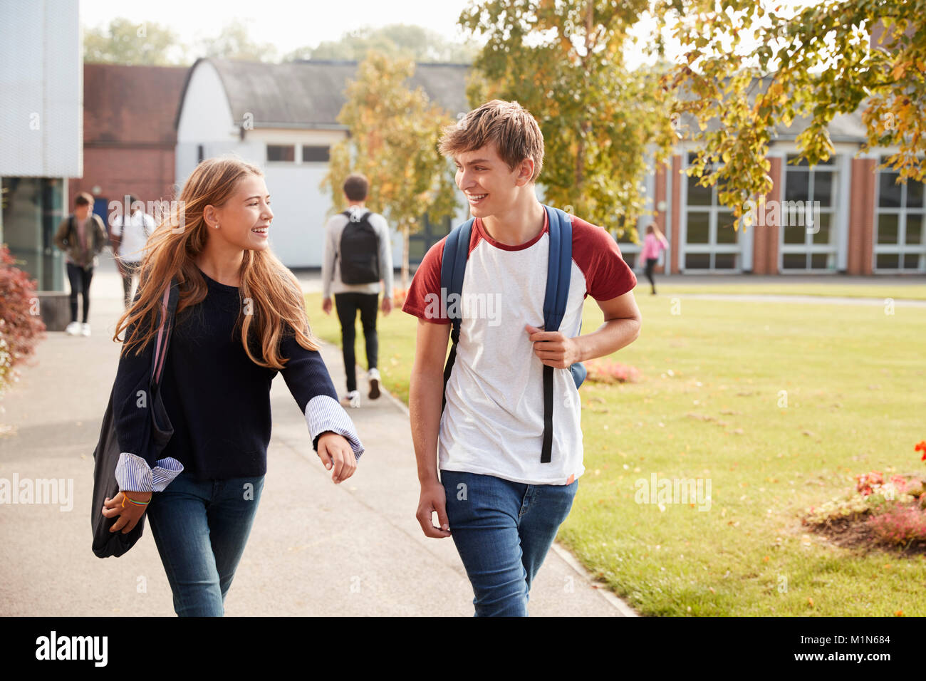 Teenage Students Walking autour de Campus d'ensemble Banque D'Images