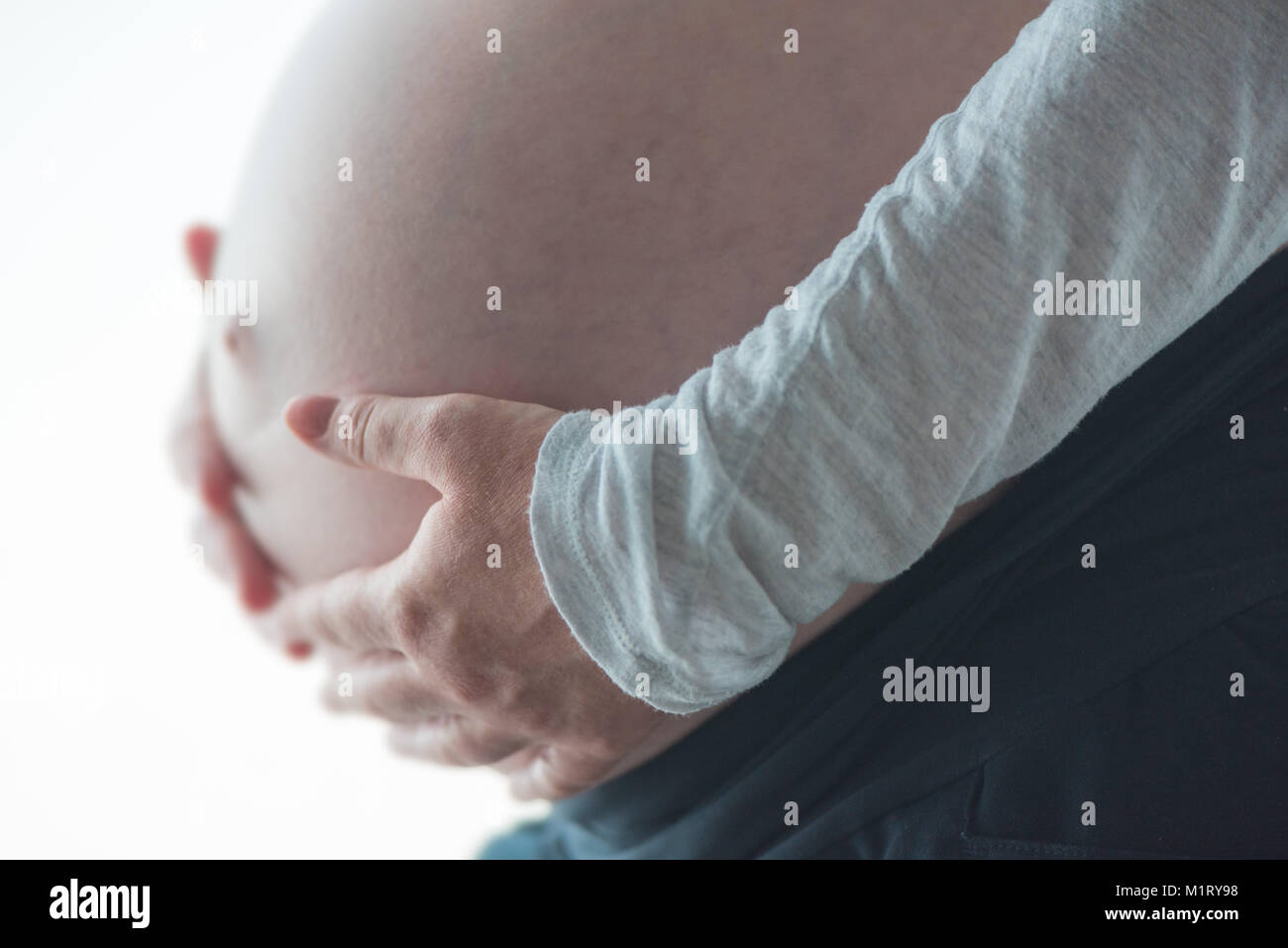 Le ventre de la femme enceinte, personne de sexe féminin dans le neuvième mois de grossesse posant Banque D'Images