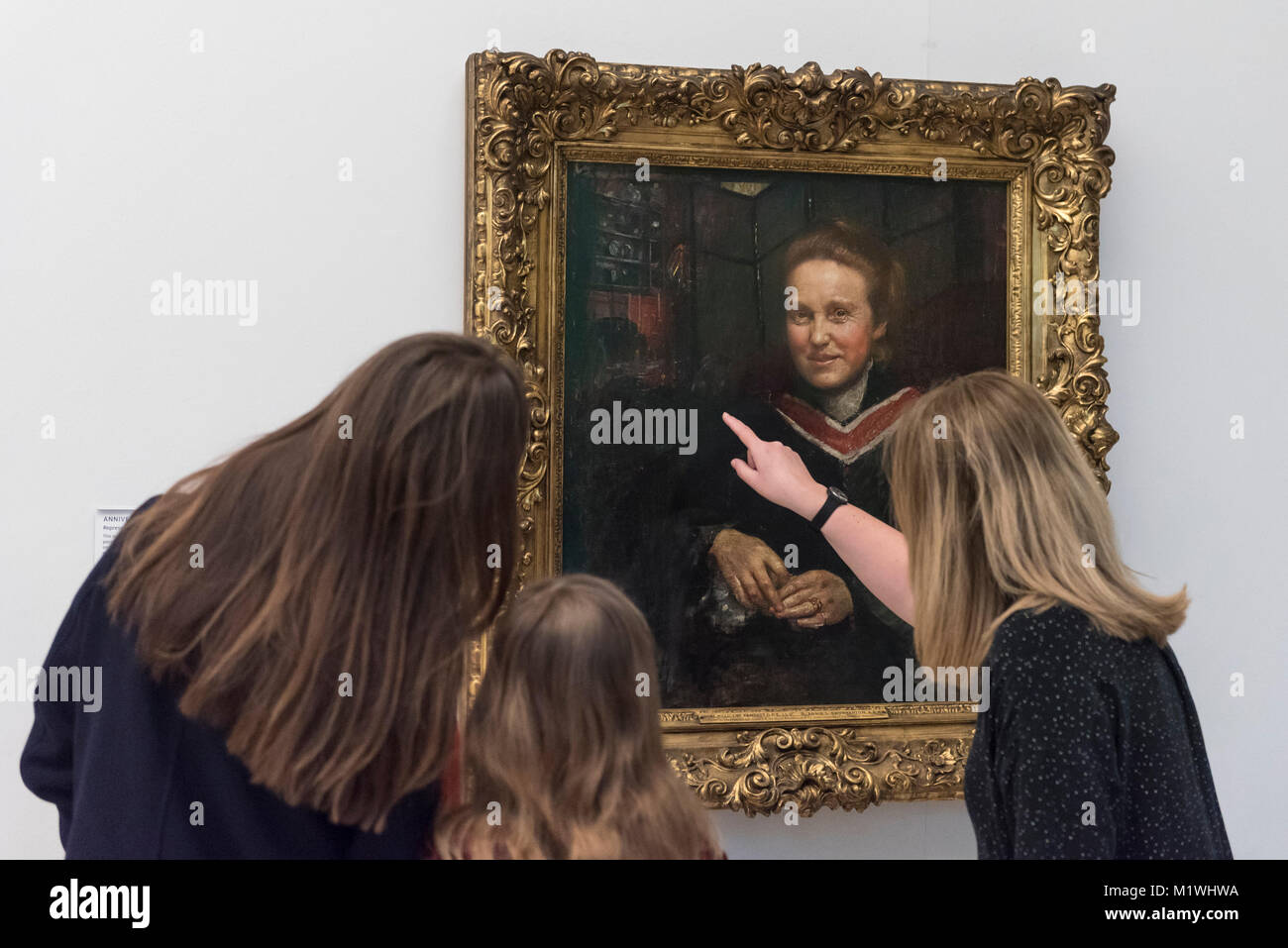 Londres, Royaume-Uni. 2e Février, 2018. Les membres du personnel, rejoint par Stella Cartwright, âgés de 9, voir un portrait de Millicent Fawcett, par Annie Swynnerton, sur l'affichage à la Tate Britain pour marquer le centenaire de la le droit de vote des femmes, telle que voulue par la Loi sur la représentation du peuple. Millicent Fawcett a été une figure de proue dans le mouvement suffragiste, campagne pour le droit de vote pour les femmes au Royaume-Uni, alors qu'Annie Swynnerton est l'une des premières femmes élues d'être membre de l'Académie Royale des Arts du Canada Crédit : Stephen Chung/Alamy Live News Banque D'Images