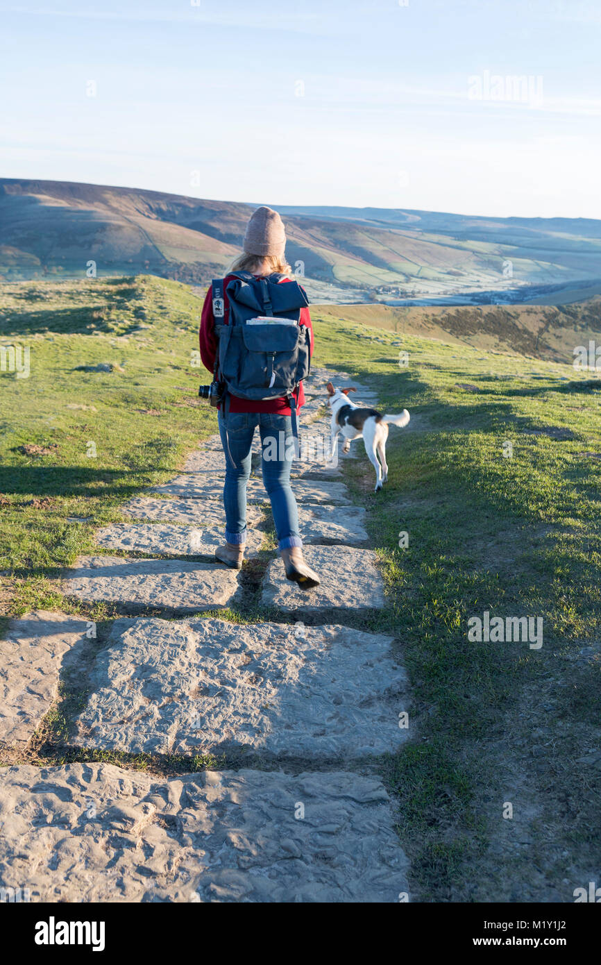 UK, Derbyshire, un promeneur et son chien sur le sentier de la crête de Mam Tor. Banque D'Images
