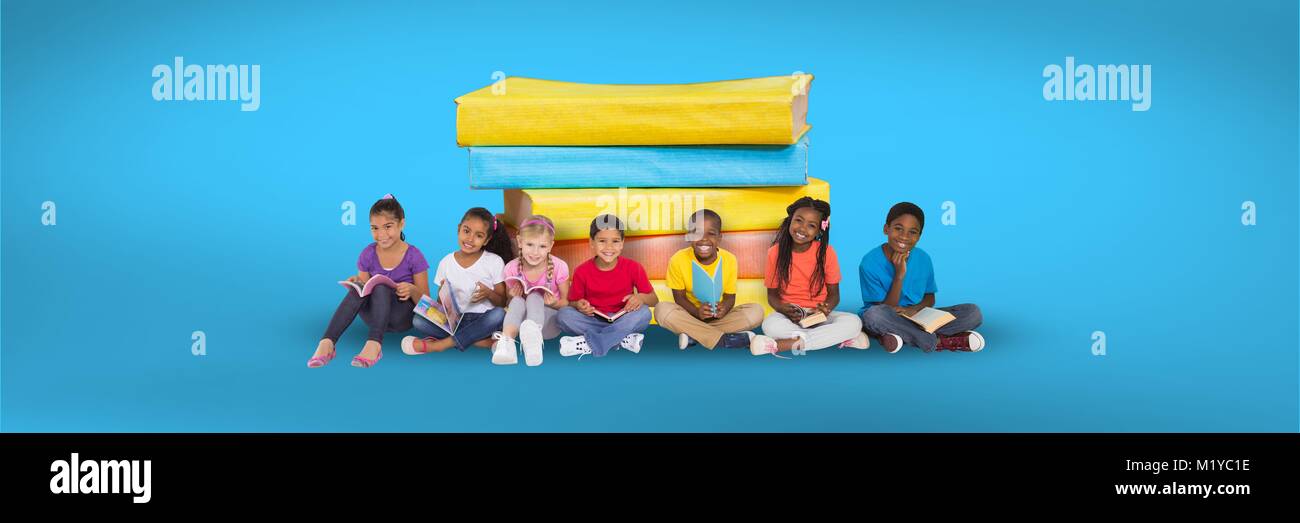 Des enfants assis sur le sol et une pile de livres avec fond bleu Banque D'Images