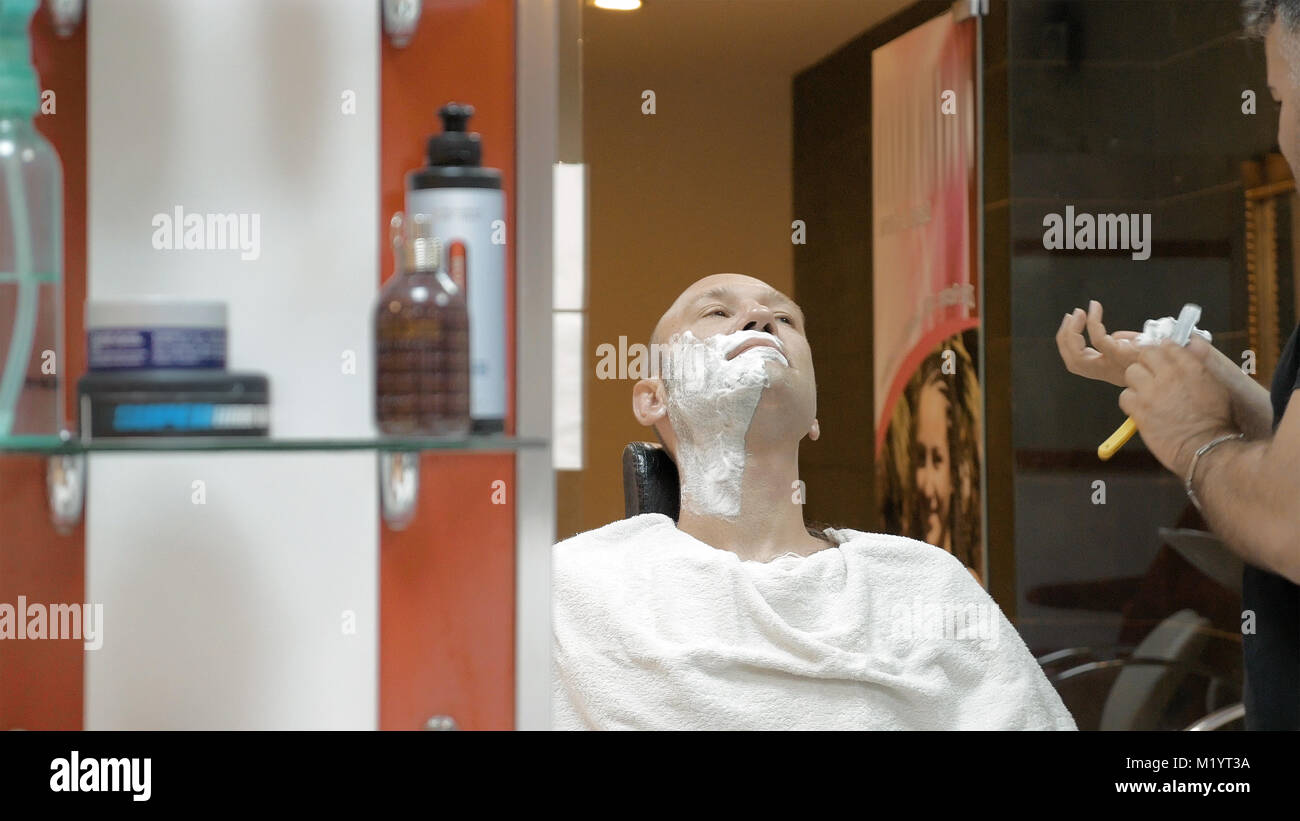 Salon de coiffure est de son client dans la vieille manière de mode Banque D'Images