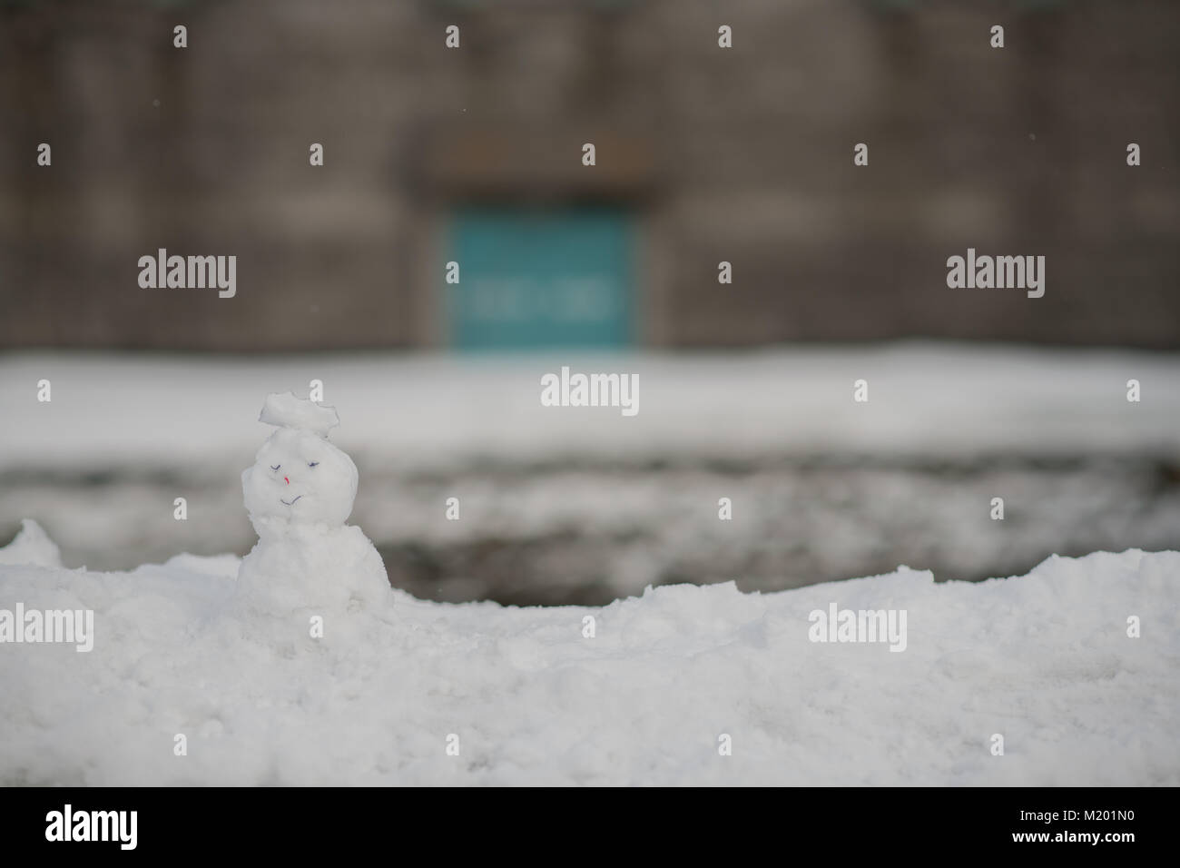 Kid jouer sculpter de neige très mignon bonhomme de neige en hiver Banque D'Images