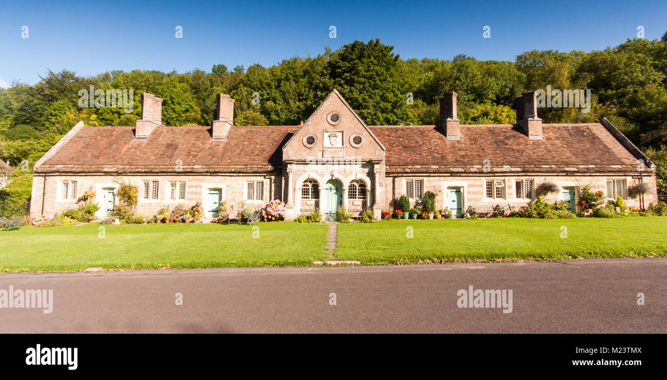 Milton Abbas, England, UK - 26 août 2012 : Une terrasse de gîtes traditionnels dans le village de Milton Abbas en Angleterre's Dorset Downs. Banque D'Images