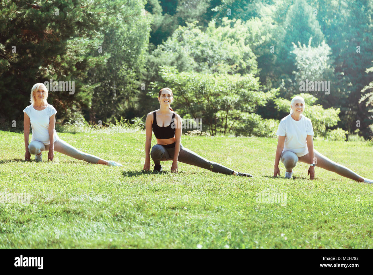 Cheerful positive women exercising outdoors Banque D'Images