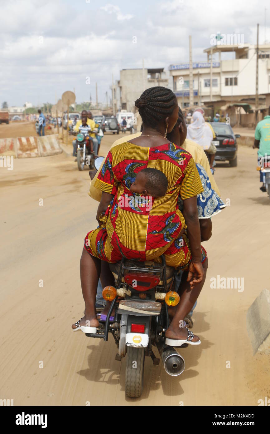 Femme avec bébé à l'arrière au moteur Zemidjan taxi Banque D'Images