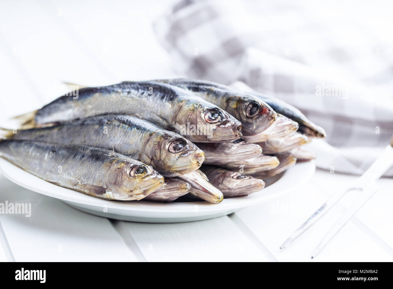 Sardines crues poisson sur la plaque. Banque D'Images