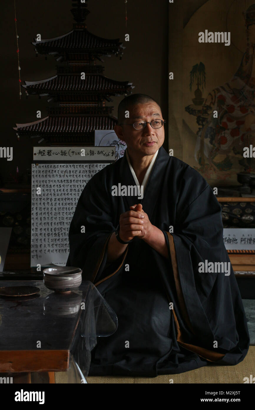 Assis très élégamment dans sa robe noire et fluide, le seul moine de la minuscule Senko-ji, M. Obayashi, médite dans les montagnes près de Kyoto, Japon Banque D'Images