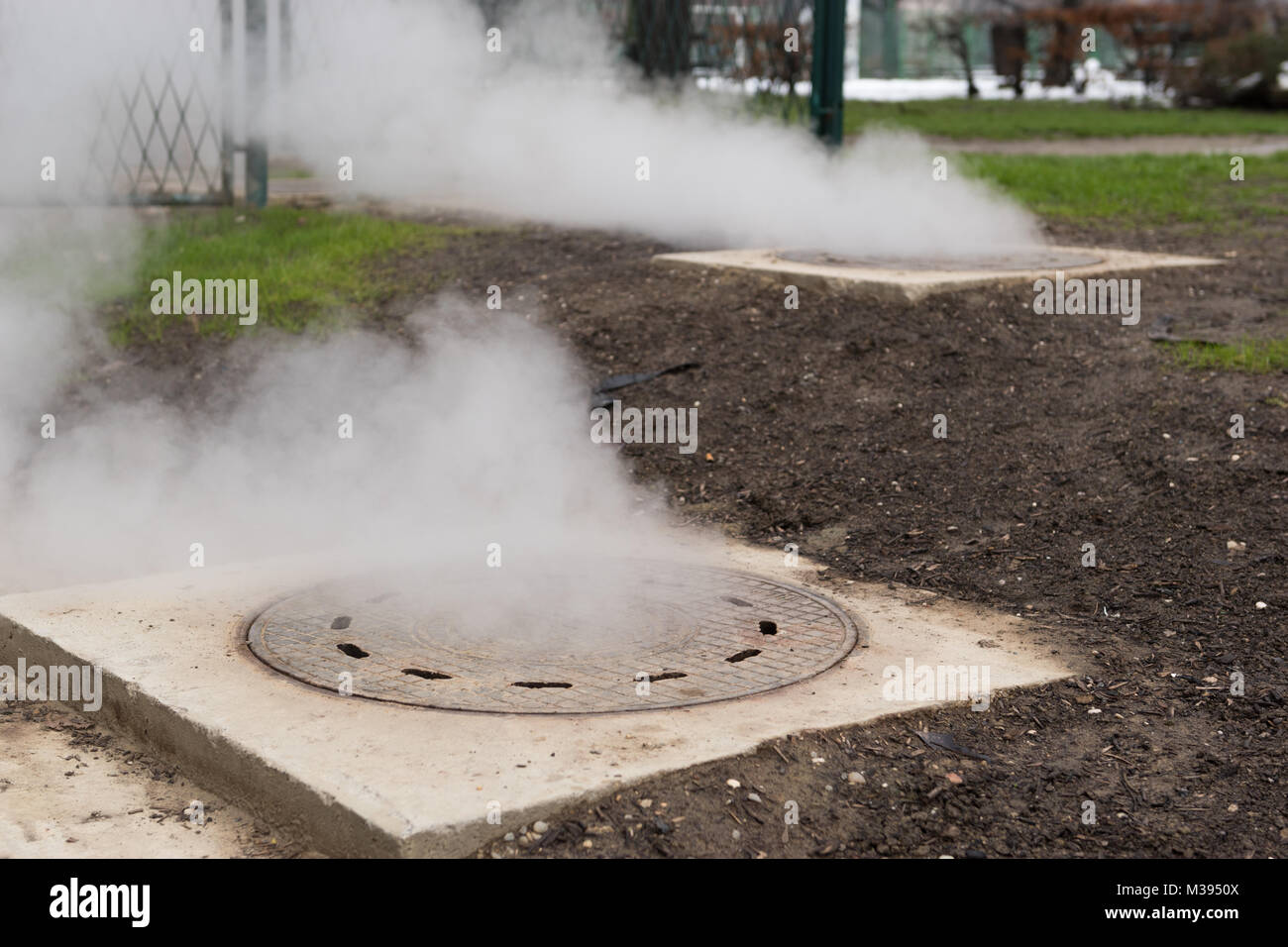 Hot white vapeur s'échappant de metal ou de trou d'écoutille métallique Banque D'Images