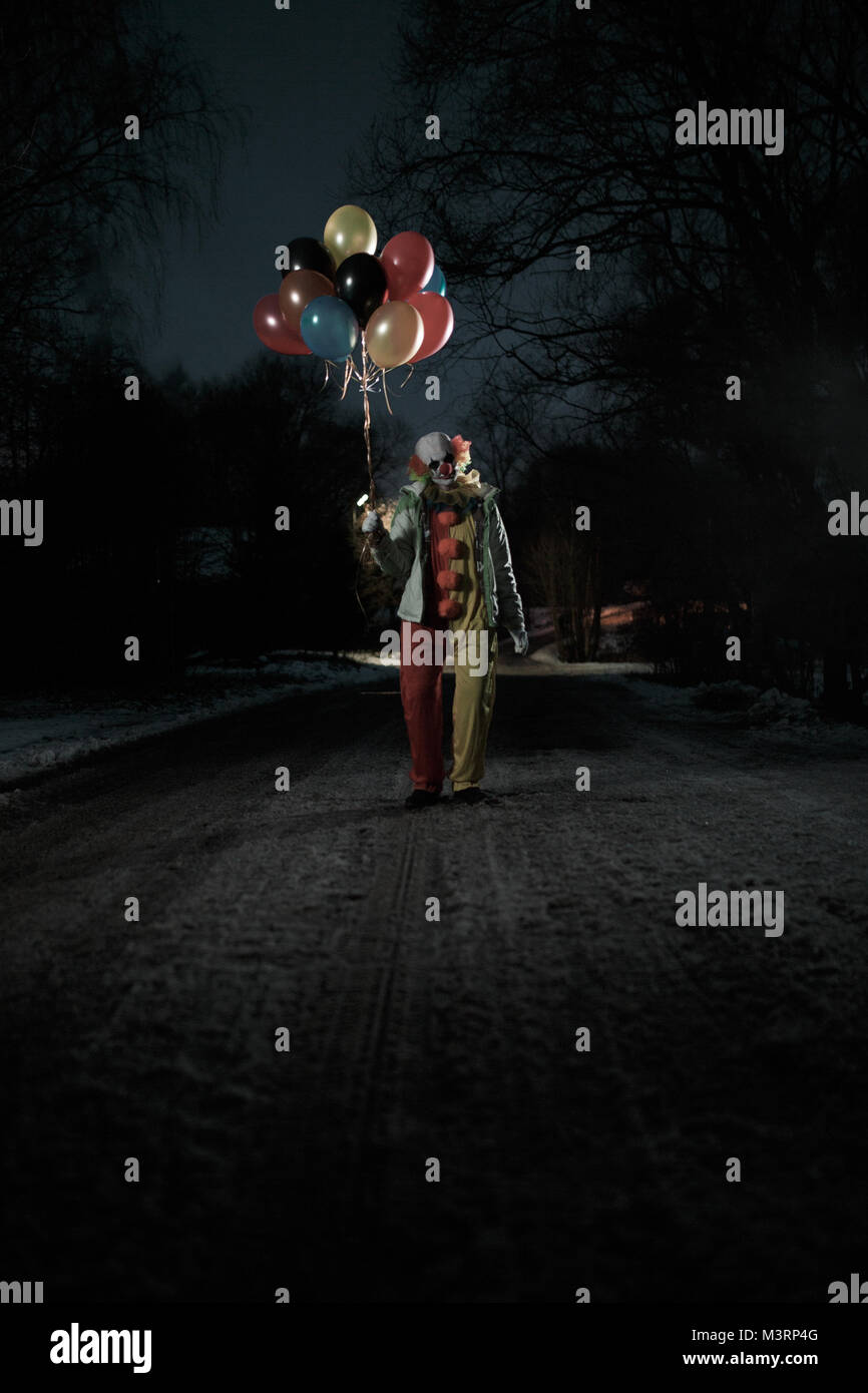 Image de clown avec des boules dans les mains la nuit sur la rue Banque D'Images