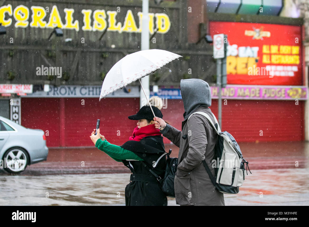 Blackpool, Lancashire. Feb 13, 2018. Météo France : froid, humide et venteux de commencer la journée sur la promenade du front de mer de Golden Mile. Normalement, un refuge pour la moitié des visiteurs à long terme cette ans pause à mi-parcours est sans l'Showzam événement qui permet de wow la foule dans les années précédentes. Des pluies torrentielles font qu'il est difficile pour les touristes et visiteurs qui se débattent avec les fortes rafales, et les rafales de vent. La prévision est de poursuivre et de fortes pluies persistantes souvent lentement vers l'est avec des vents forts. /AlamyLiveNews MediaWorldImages : crédit. Banque D'Images