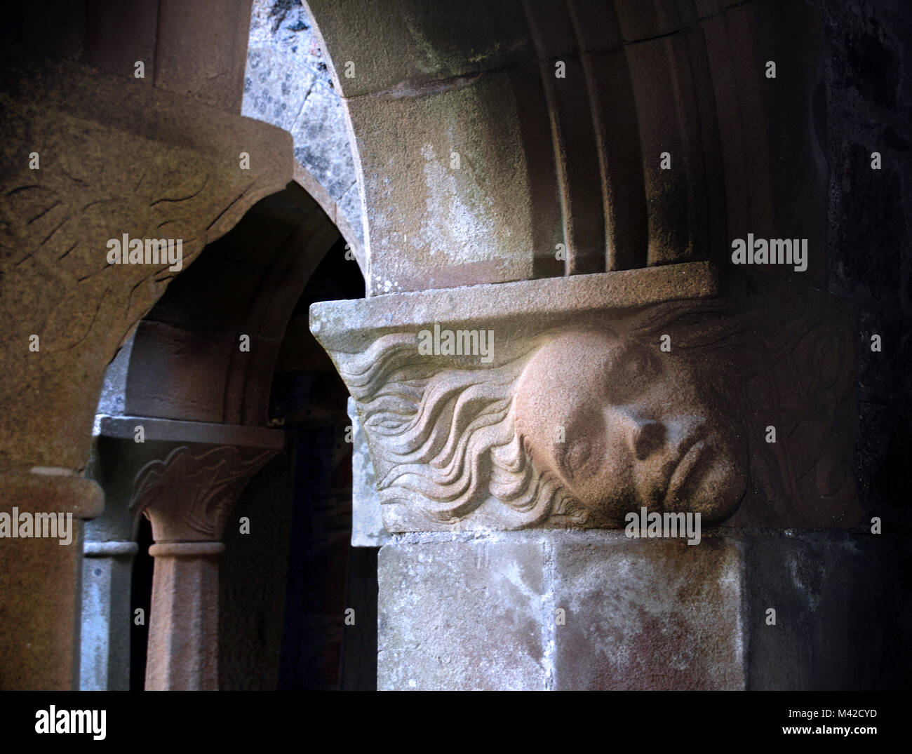 Sculpture en pierre de sable d'un visage incorporé dans l'Arcades du cloître de l'abbaye d'Iona, Banque D'Images