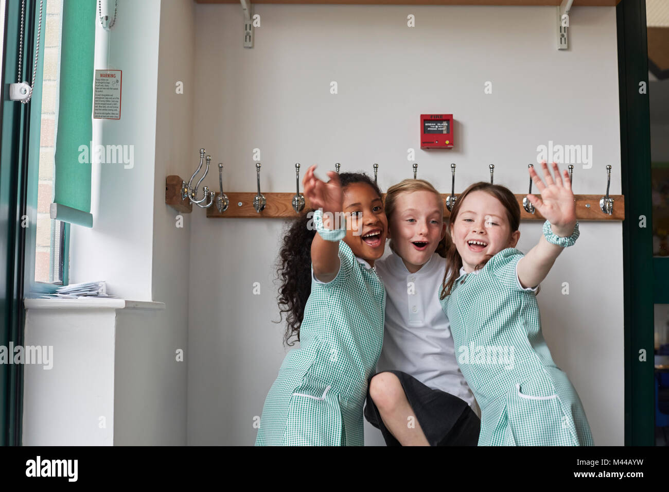 Trois jeunes filles s'amusant à l'école primaire vestiaire Banque D'Images