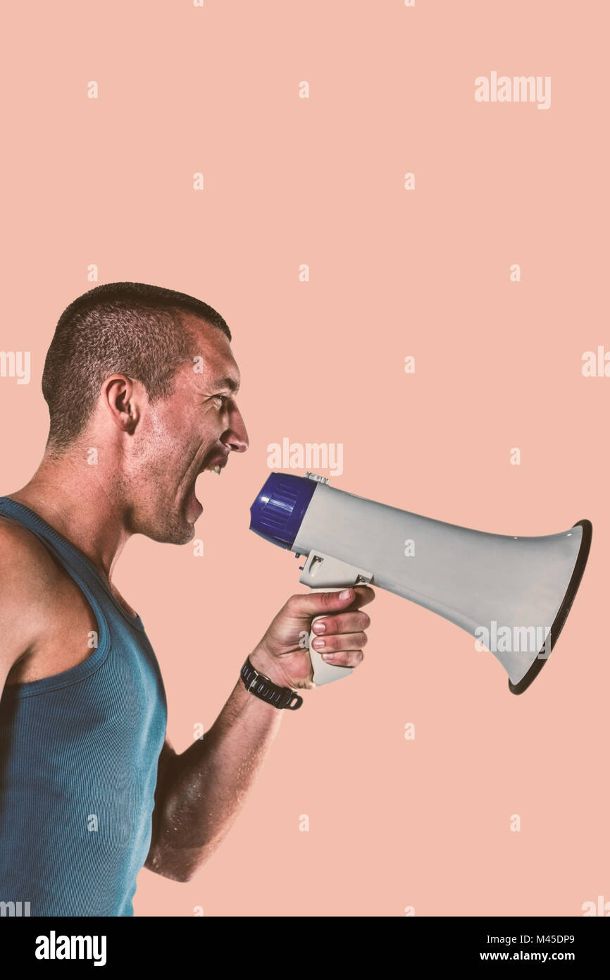Image composite de angry male trainer yelling through megaphone Banque D'Images