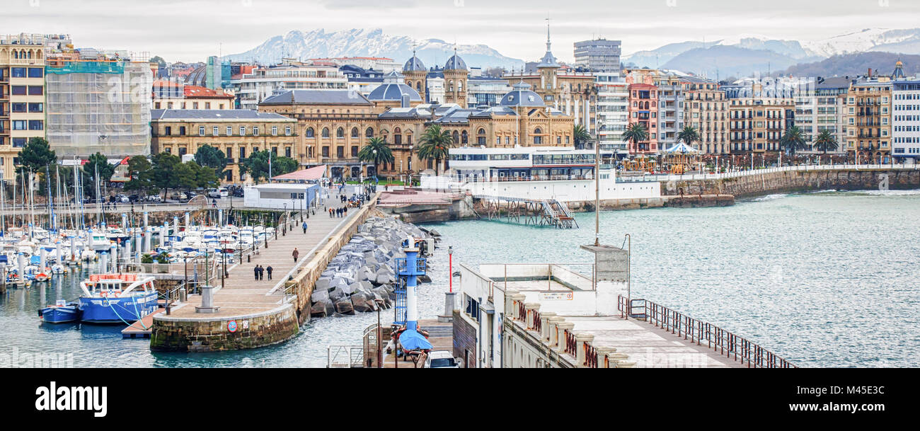 Panorama de San Sebastian (Donostia) en journée d'hiver nuageux avec les montagnes enneigées à l'horizon. Banque D'Images