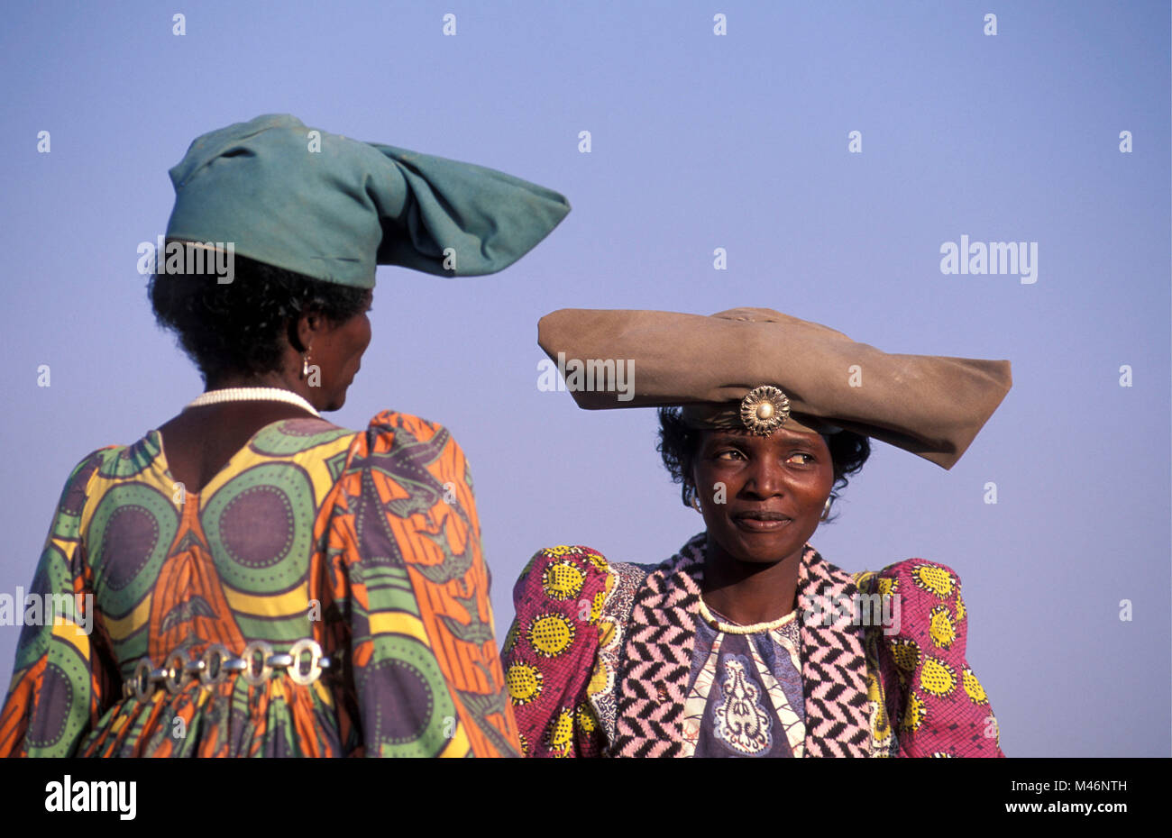 La Namibie. Kaokoveld, près d'Opuwo. Les femmes Herero. Vicotorian typique robe et chapeau. Banque D'Images