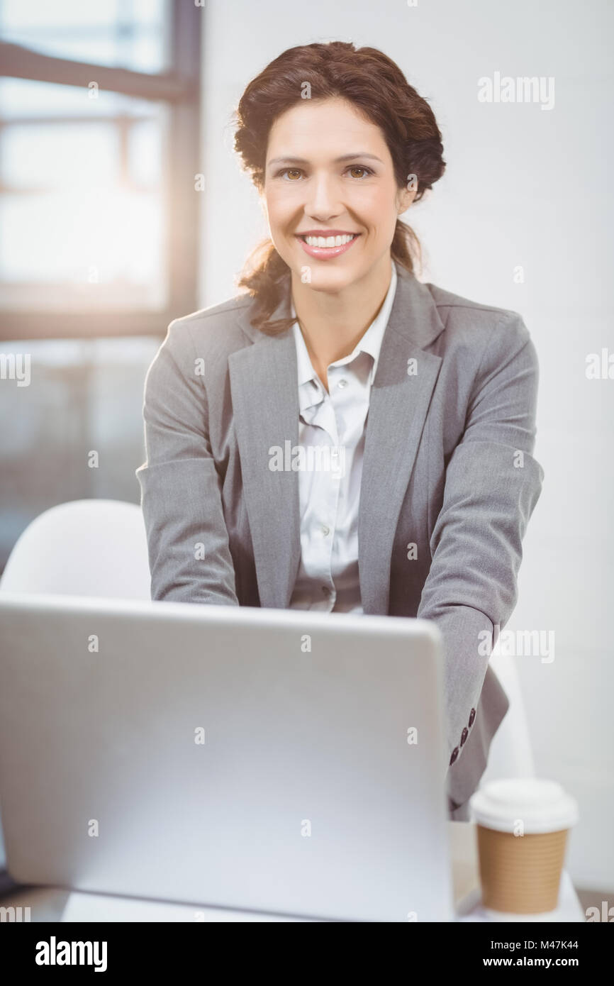 Beautiful businesswoman using laptop in office Banque D'Images