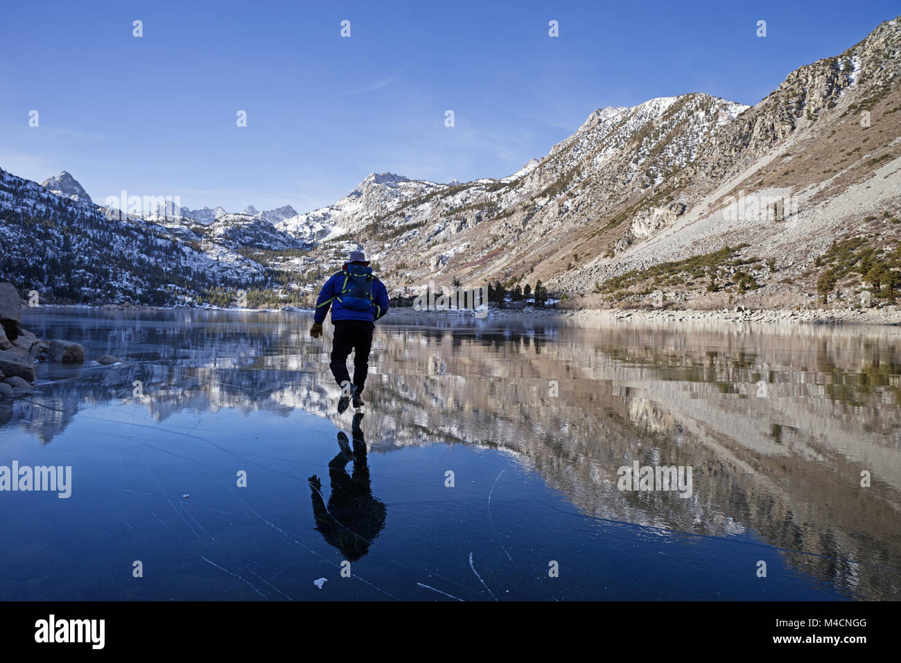 L'homme du patin à glace sur le lac de Sabrina dans les montagnes de la Sierra Nevada Banque D'Images