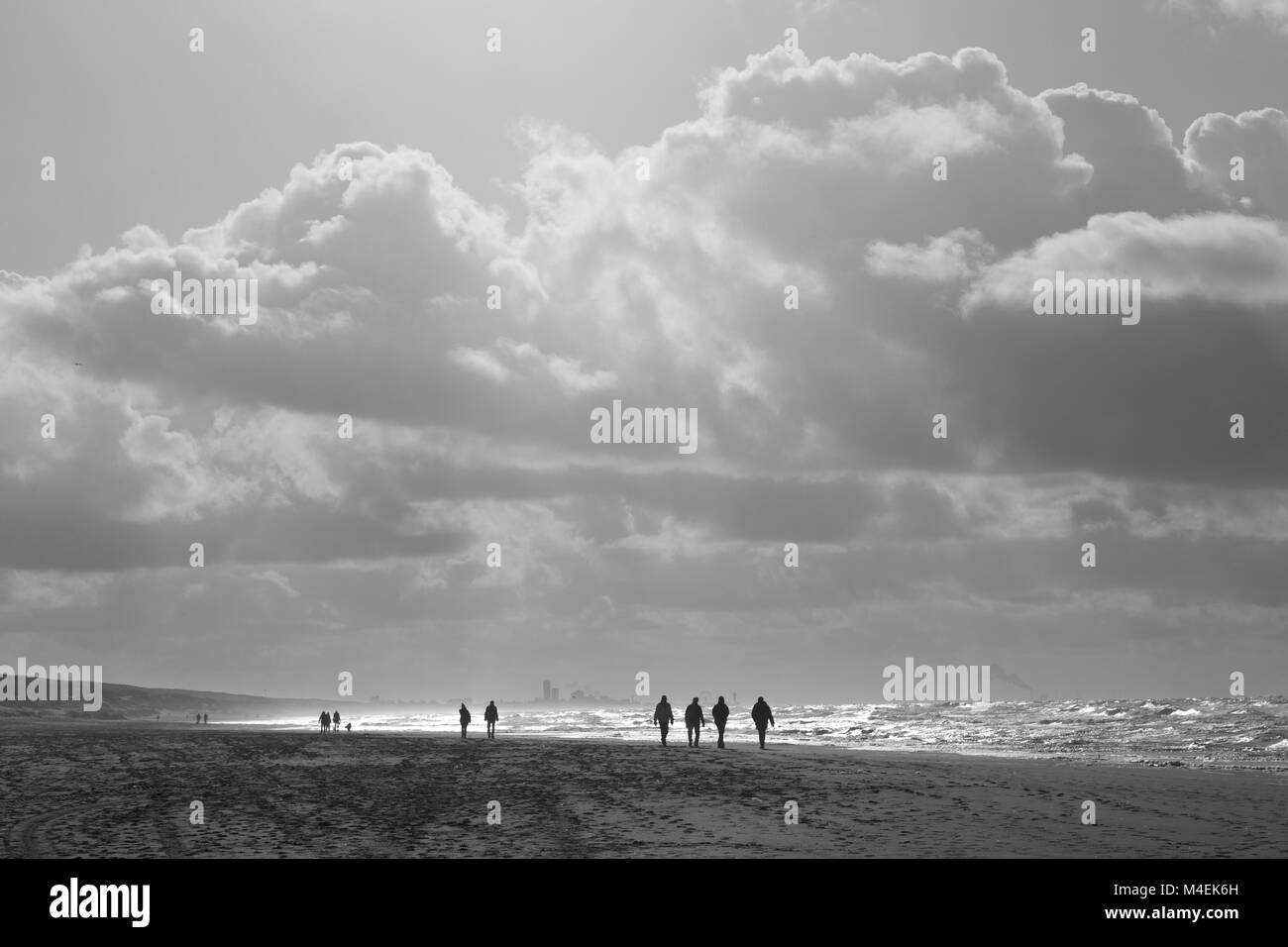 Capture de contre-jour des marcheurs silhouettés sur la plage de Katwijk, Hollande du Sud, pays-Bas, Europe. Banque D'Images