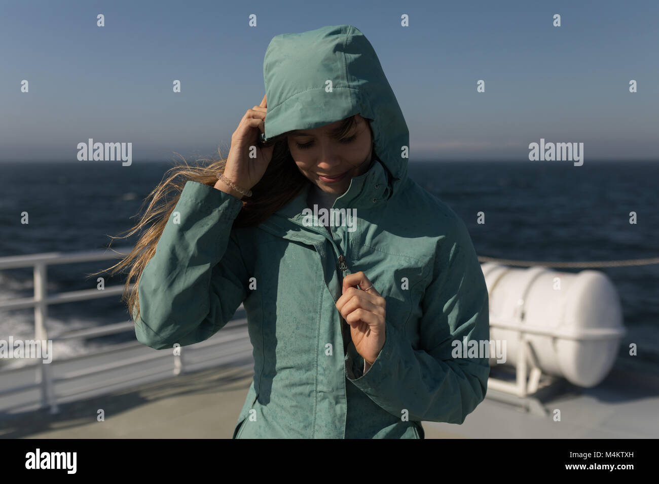 Woman in hoodie article on cruise ship Banque D'Images