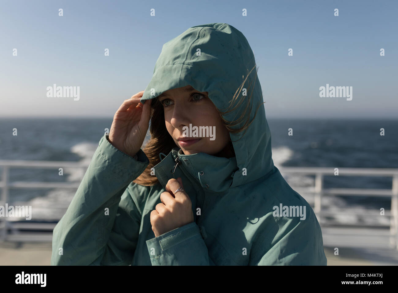 Woman in hoodie article on cruise ship Banque D'Images