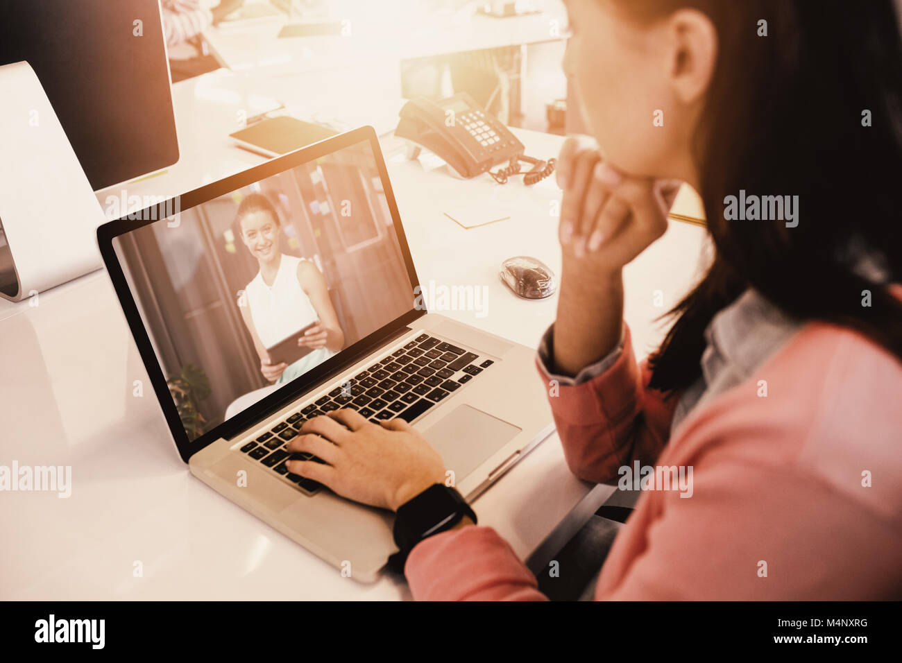 Image composite de woman working on laptop at office Banque D'Images