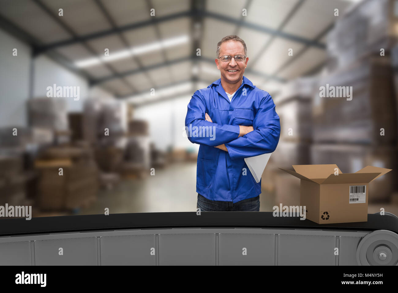 3d composite image of warehouse manager standing with arms crossed Banque D'Images