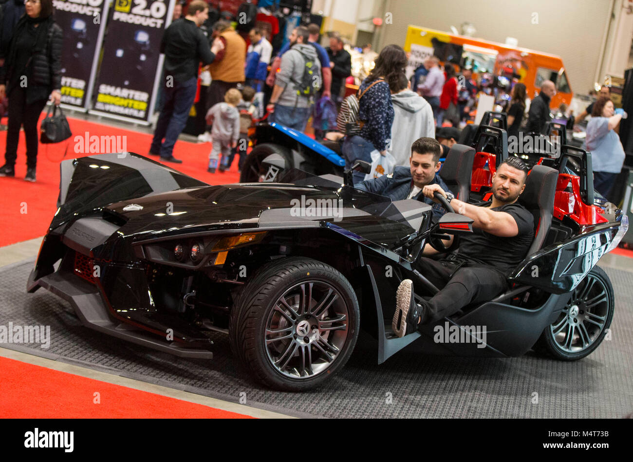 Toronto, Canada. Feb 17, 2018. Deux visiteurs monter sur une motocyclette à trois roues pendant le 2018 Salon de la moto de Toronto à Toronto, Canada, le 17 février 2018. Avec des centaines de motos, scooters, quads et plus, world's top marques moto présenter leurs nouveaux produits et de la technologie à des amateurs d'ici le 16 février à 18, 2018. Credit : Zou Zheng/Xinhua/Alamy Live News Banque D'Images