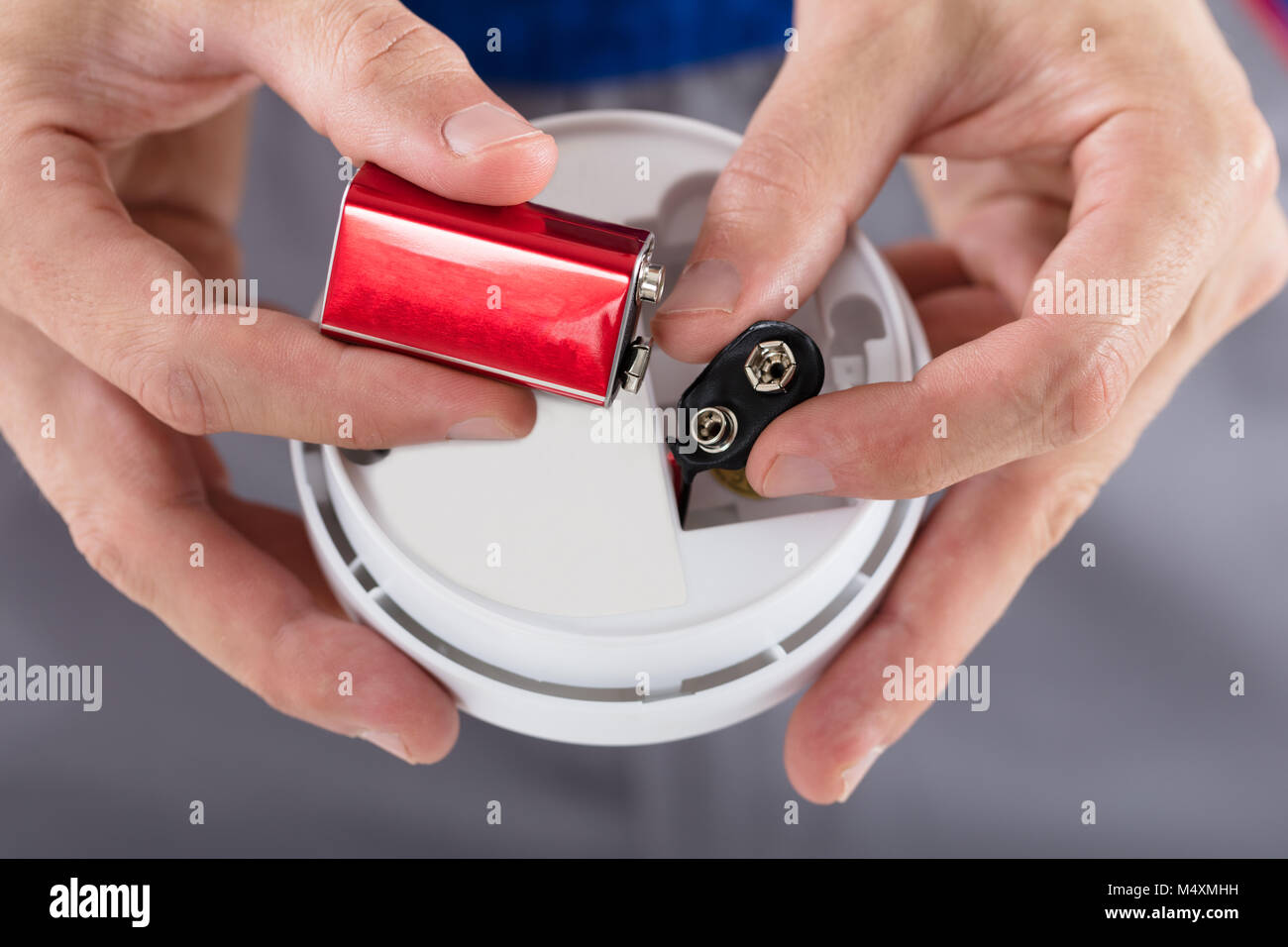 Close-up of a person's Hand Inserting Batterie de détecteur de fumée Banque D'Images