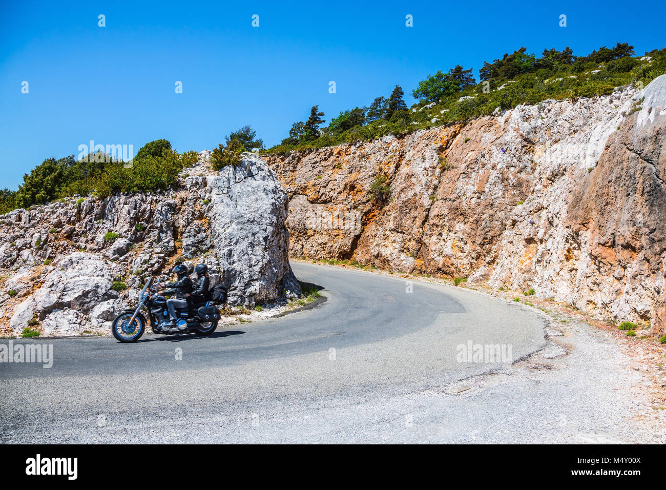 Moto avec deux motocyclistes sur une route de montagne Banque D'Images