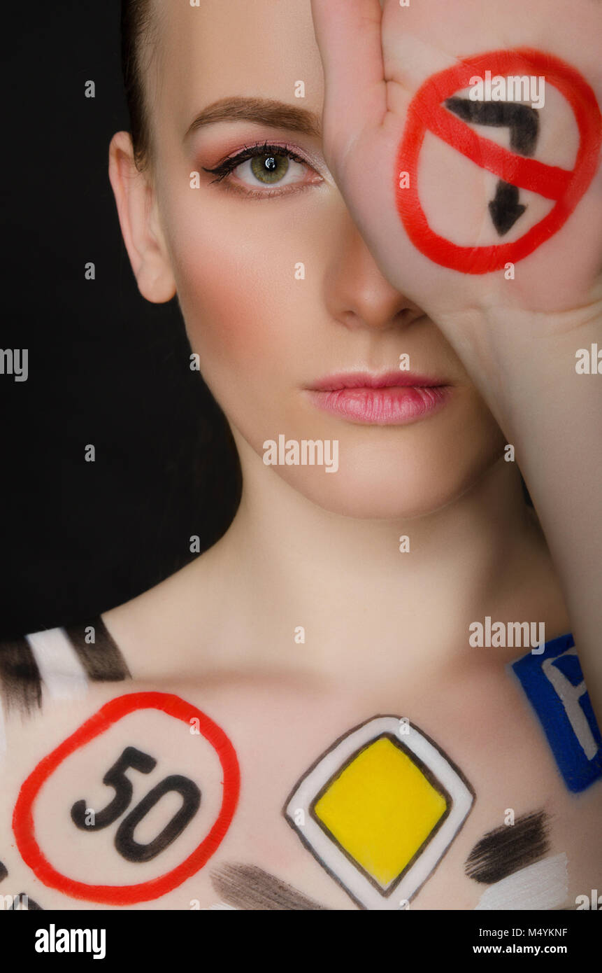 Femme avec la signalisation routière peinte Banque D'Images