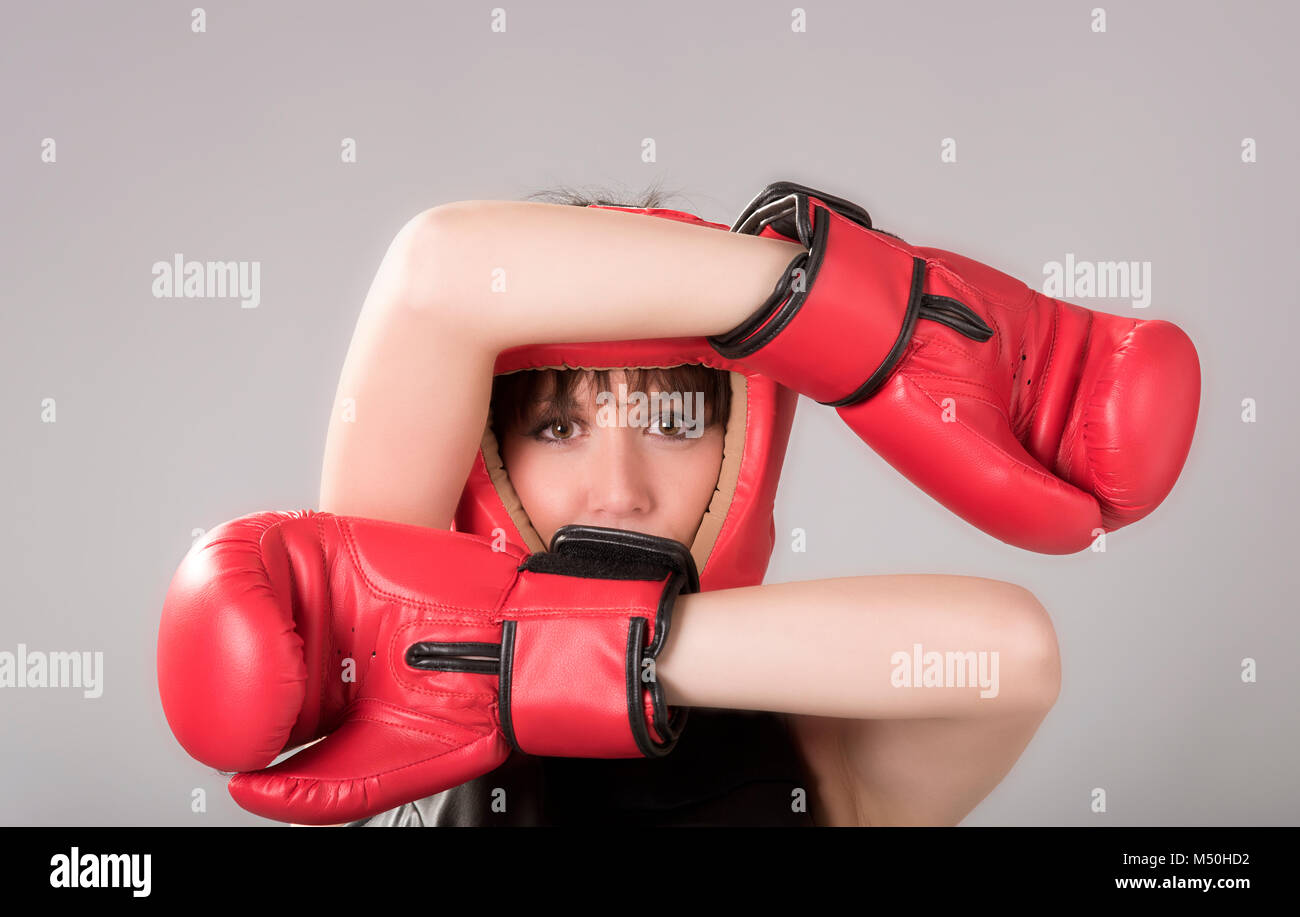 Femme portant des gants de boxe et un casque rouge Banque D'Images