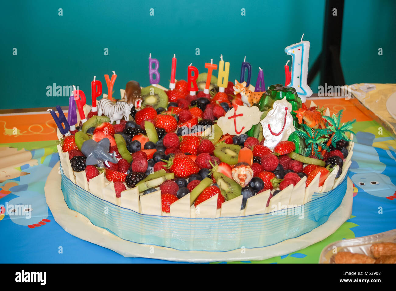 Un Premier Anniversaire Gateau Decore Avec Des Fruits D Ete Animaux Et Des Bougies D Anniversaire Photo Stock Alamy
