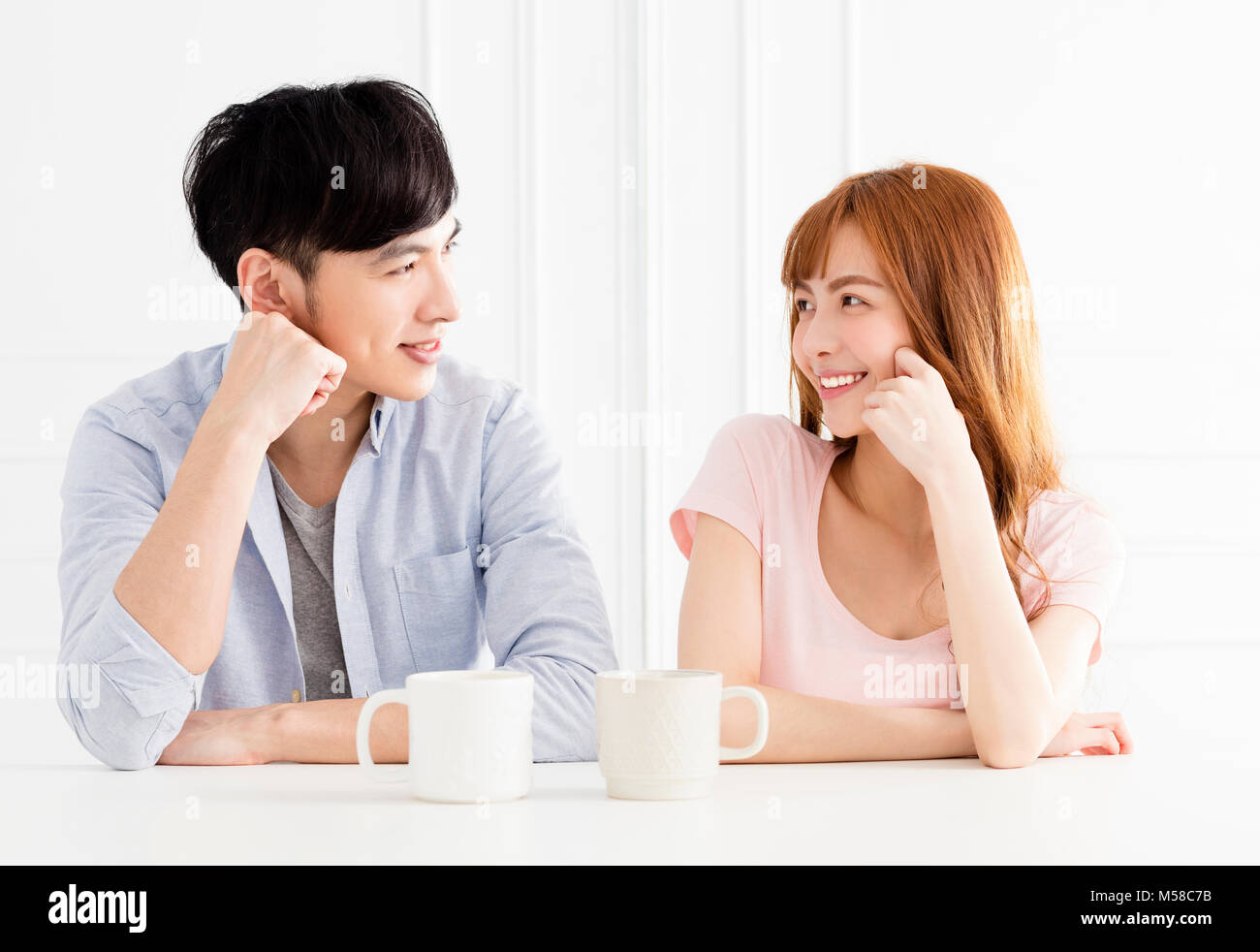 Young Asian Woman drinking coffee in living room Banque D'Images