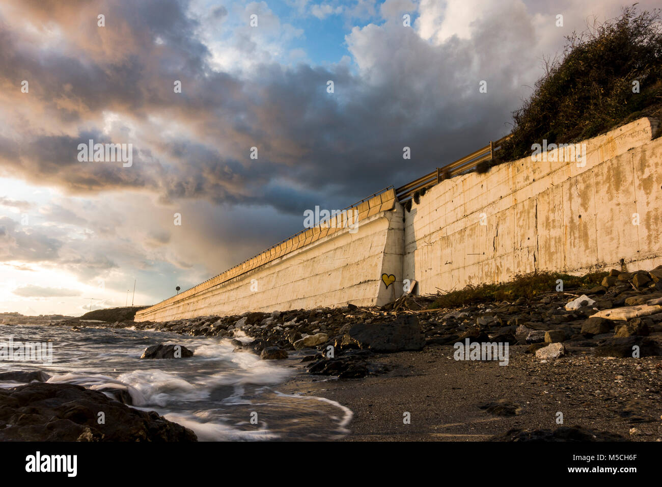 Mur en béton le long de la côte, avec l'autoroute N340, au-dessus de la circulation, El Faro, Andalousie, espagne. Banque D'Images