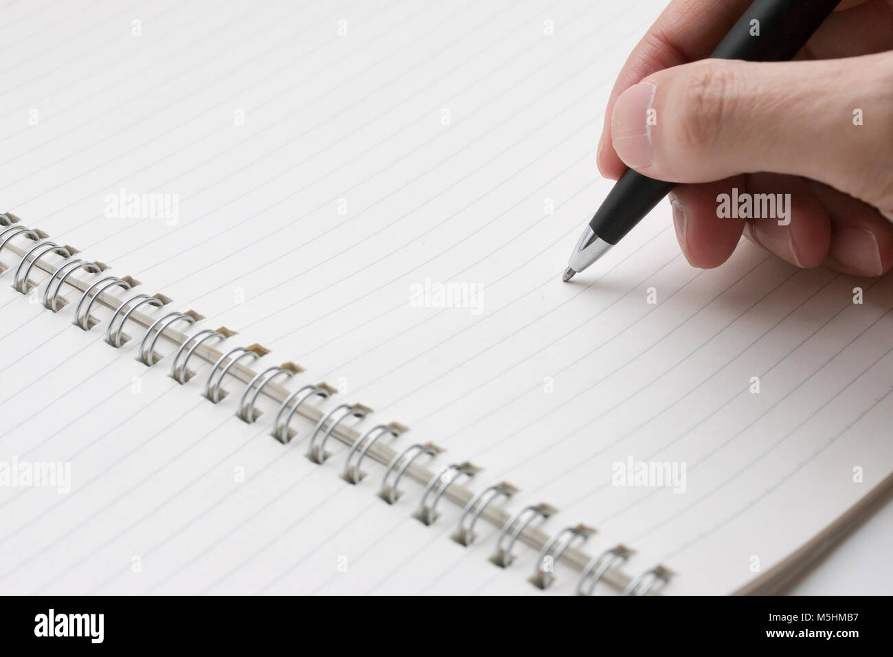 Un stylo à bille a été tenue dans la main prêt à écrire dans la note book Banque D'Images