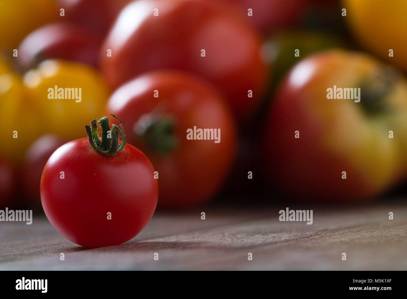 Tomates colorées sur fond de bois rustique. Profondeur de champ. Banque D'Images