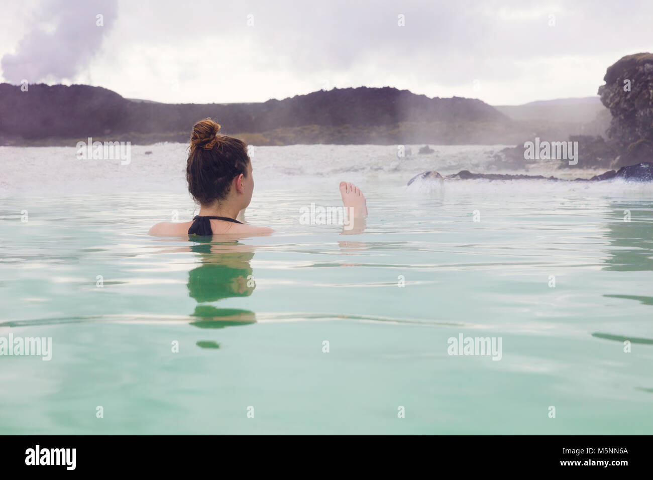 Woman Relaxing in Hot Spring à l'Islande de plein air Banque D'Images