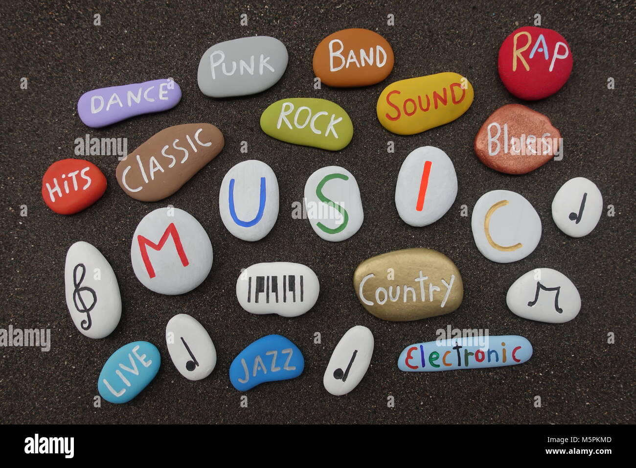 Music cloud avec pierres multicolores sur sable volcanique noir Banque D'Images