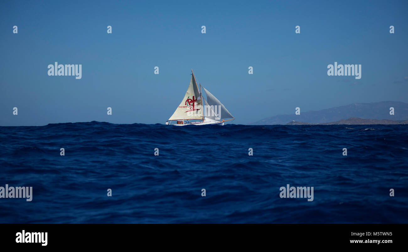 Un bateau de pêche traditionnel grec la voile vers l'île de Paros. Le signe sur la voile dit "la liberté ou la mort". Banque D'Images